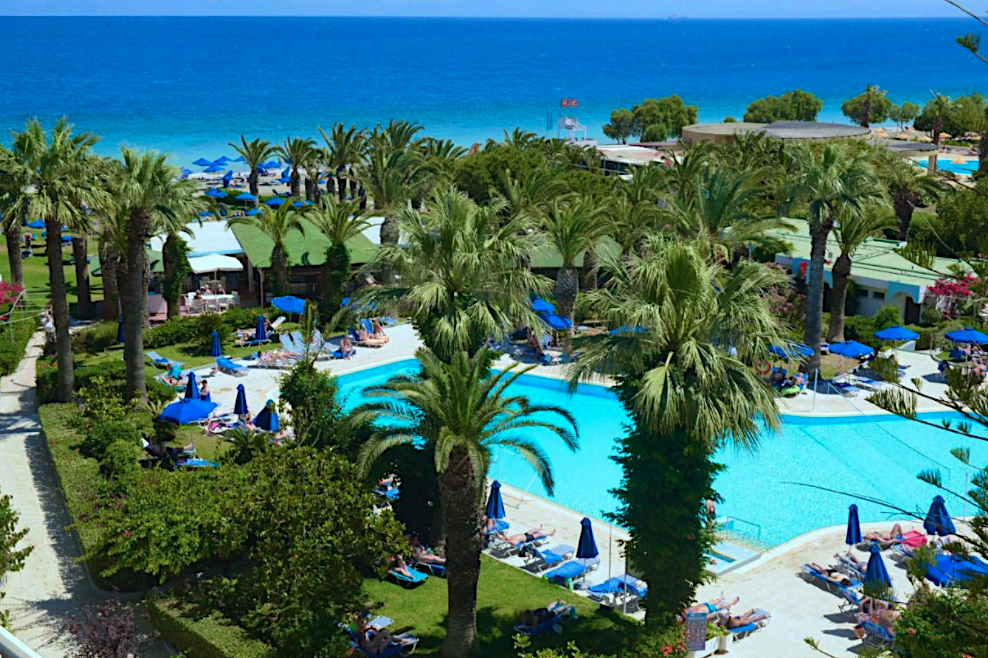Blick auf den Pool des Blue Horizon Beach Resort in Ialysos mit Palmen und Sonnenliegen