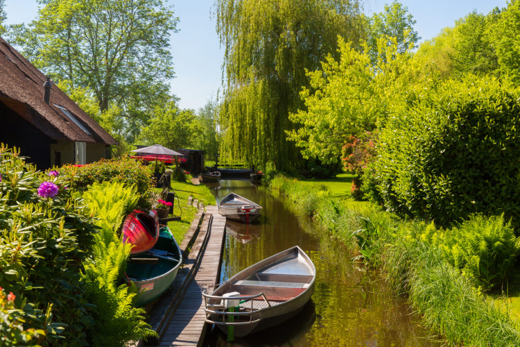 Giethoorn, Netherlands, May 30, 2021. The famous village of Giethoorn in the Netherlands with traditional dutch houses, gardens and water canals and wooden bridges is know as "Venice of the North