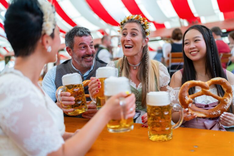 Group,Of,Friends,At,Oktoberfest,Tent,Joyfully,Cheers,With,Frothy