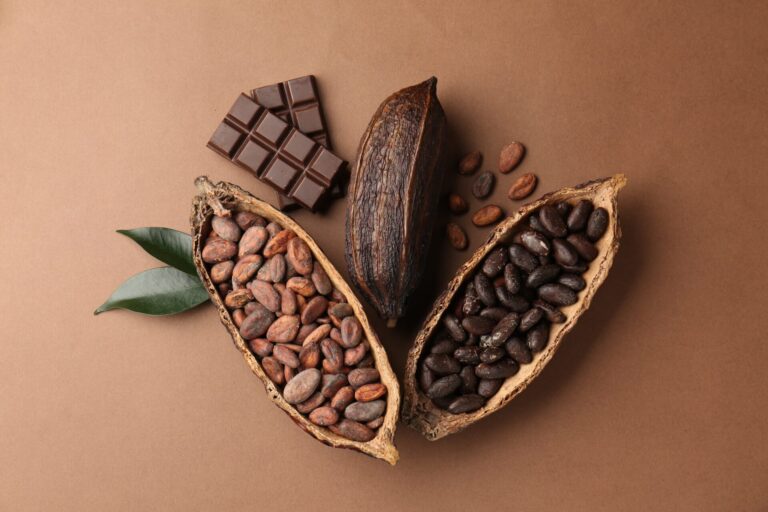 Cocoa,Pods,With,Beans,,Chocolate,And,Leaves,On,Brown,Background,
