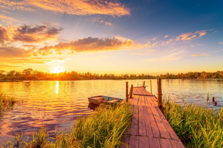 Sunset,Over,The,Lake.,Wooden,Village,Bridge,With,A,Boat.