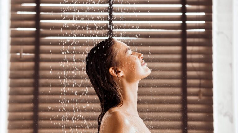 Beautiful,Woman,Taking,Shower,,Standing,Under,Water,Drops,,Side,View,